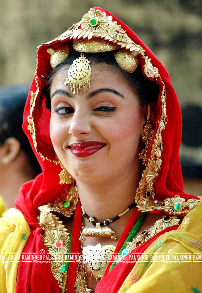 An Indian college girl getsures at her team mate, unseen in the picture, before she performs on stage in the annual Youth Festival at Guru Nanak Dev University campus in Amritsar city, India, on Monday, October 24, 2005.