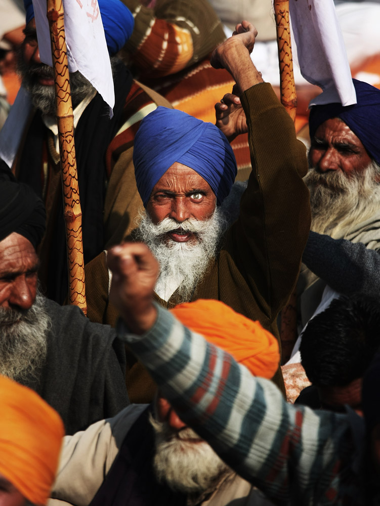 A Sikh farmer with a false eye protests along with others