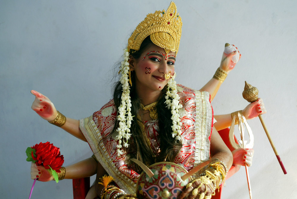 An Indian girl dressed as Hindu Goddess Durga, poses for a photograph as she waits to take part in a religious procession taken out on the eve of Janamashtmi or the birth anniversary of Lord Krishna in Amritsar, India, 09 August 2012. Lord Krishna the eighth of the 10 incarnations of Hindu God Lord Vishnu who is considered the Preserver of the Universe is one of Hinduism's most popular gods and his birth anniversary or Janamashtmi will be celebrated on 10 August 2012.