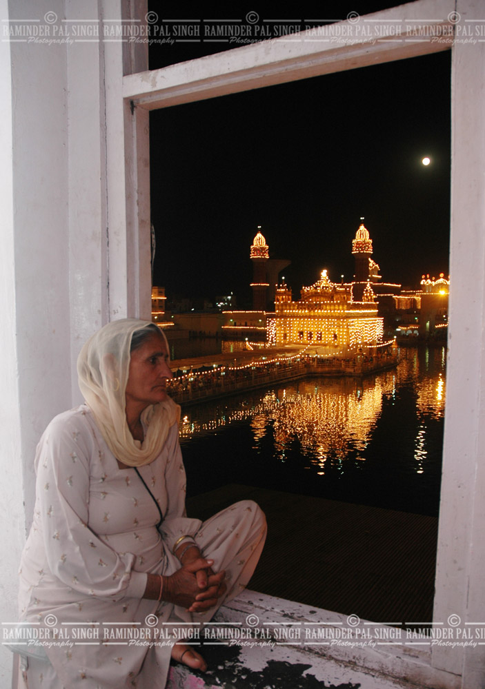 Golden Temple in a window woman watches