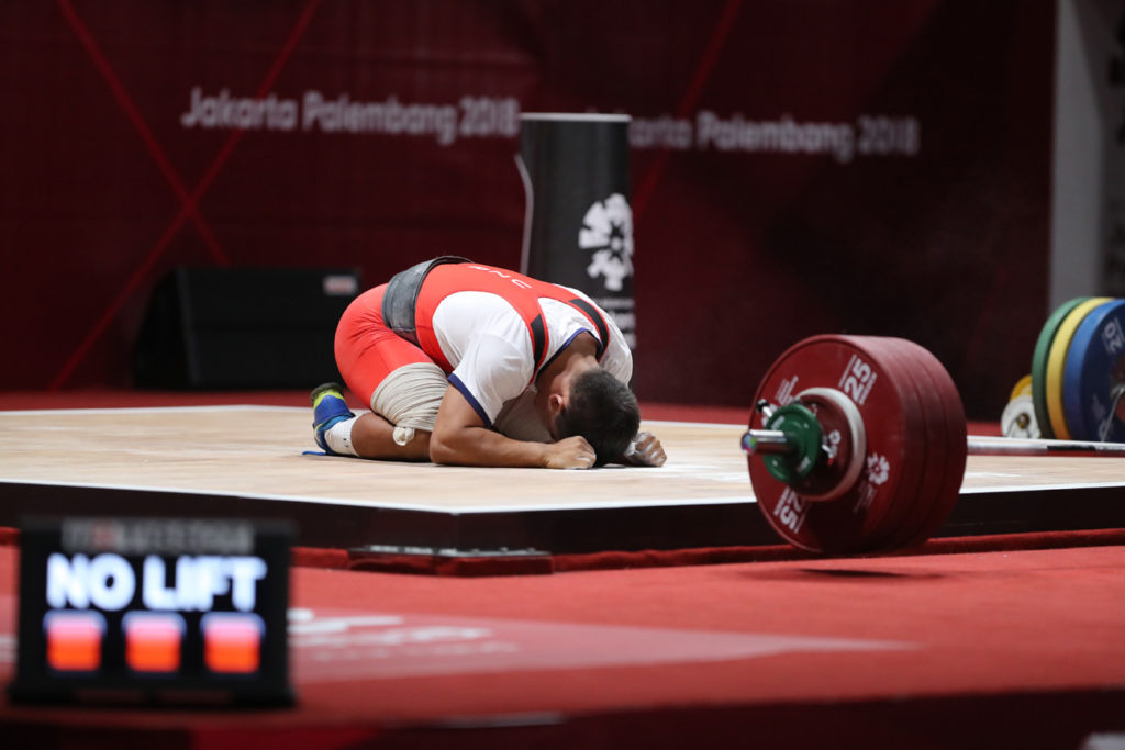 unsuccessful weightlifting attempt dejected weightlifter no lift weight on ground