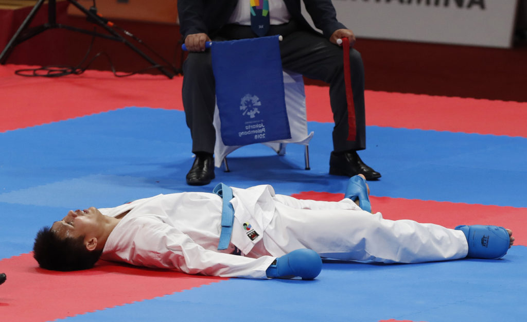 fighter on ground after taking a blow in Karate match at Asian Games Jakarta Indonesia