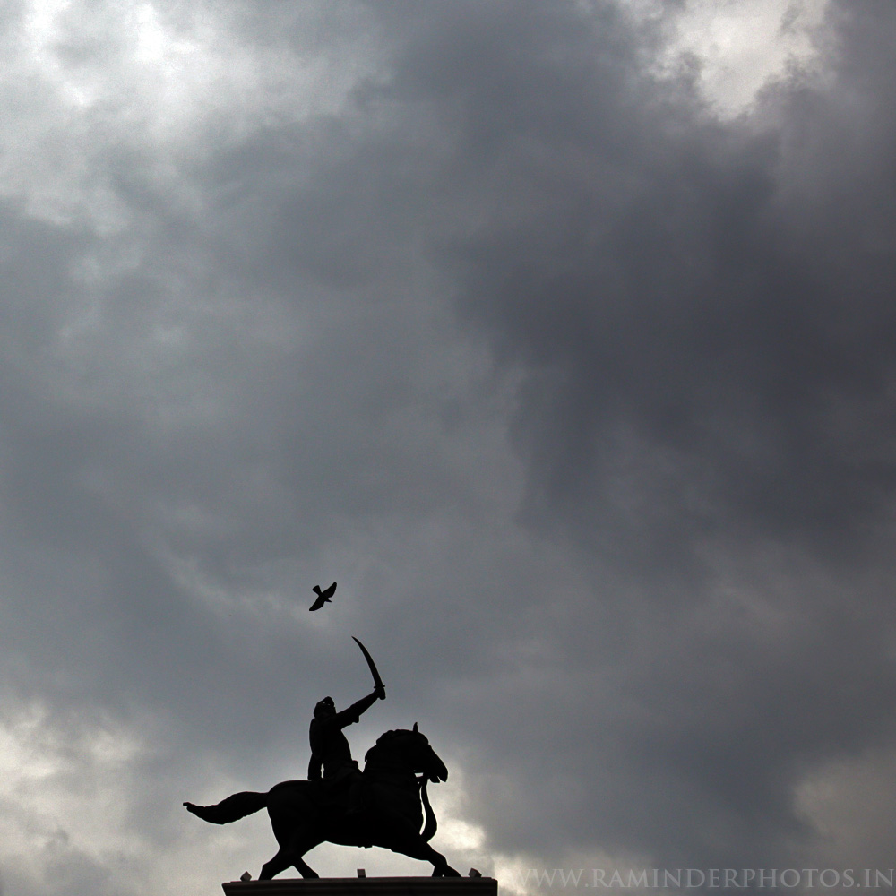 statue of Maharaja Ranjit Singh under clouds at Heritage Square