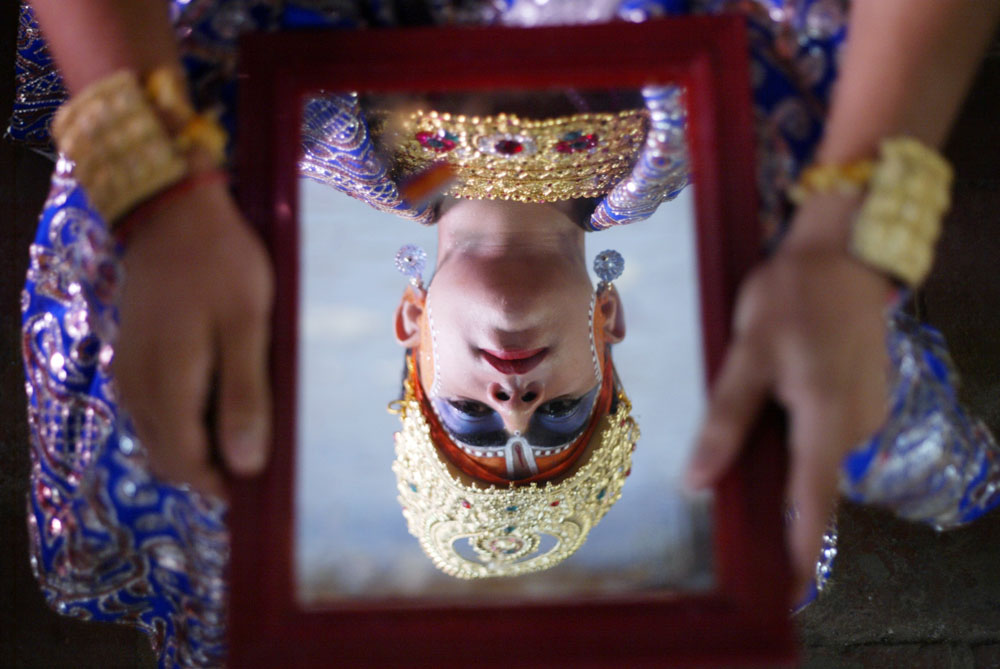 The face of an Indian child dressed as Hindu God, Lord Vishnu is reflected in a mirror as he adjusts his makeup before taking part in a religious procession taken out on the eve of Janamashtmi or the birth anniversary of Lord Krishna in Amritsar, India, 09 August 2012. Lord Krishna the eighth of the 10 incarnations of Hindu God Lord Vishnu who is considered the Preserver of the Universe is one of Hinduism's most popular gods and his birth anniversary or Janamashtmi will be celebrated on 10 August 2012.