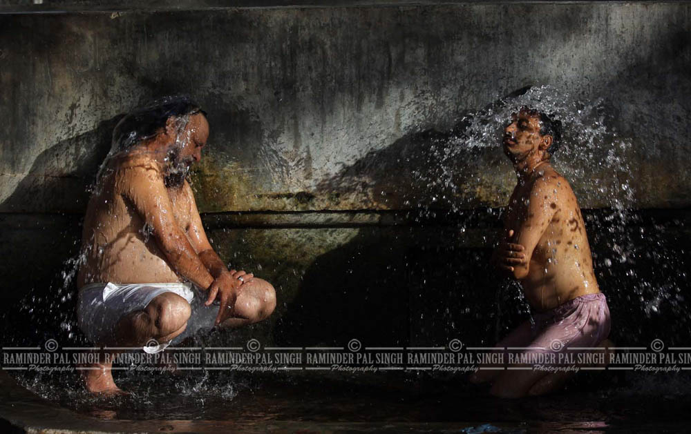 men take shower at a public bathing place