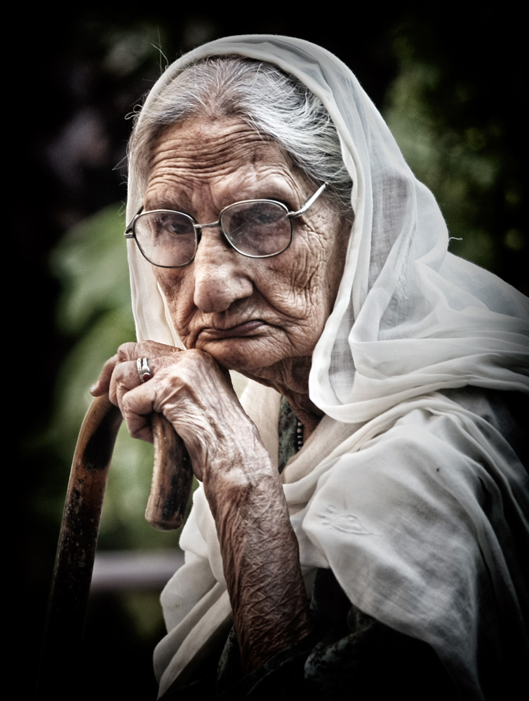 an aged woman in deep thought at an old age home