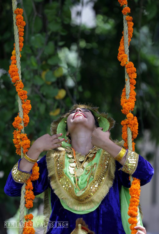 beautiful Indian Punjabi woman portrait smiling teej festival taking rides on swing