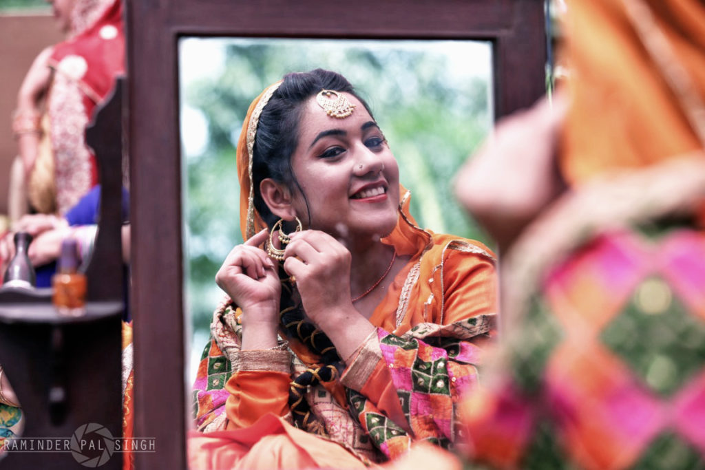 beautiful Indian Punjabi woman portrait smiling reflection in mirrorteej festival